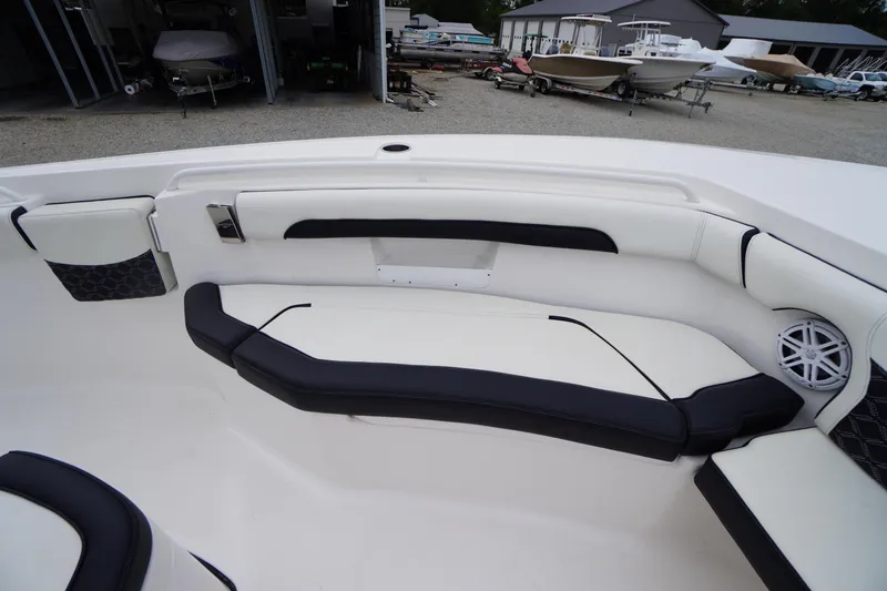 Slide: The Image of 2021 Tidewater 256 CC Adventure boat interior with cushioned seating and speaker. - 9