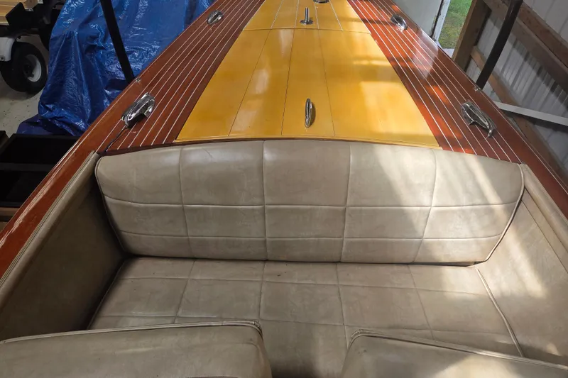 Slide: The Image of 1960 Chris Craft 19 Capri boat interior with beige seating and polished wooden deck. - 10