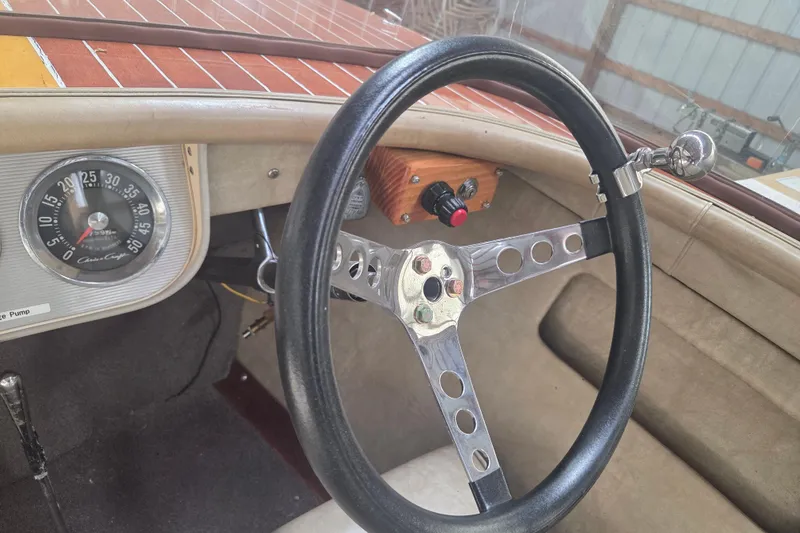 Slide: The Image of 1960 Chris Craft 19 Capri dashboard with vintage steering wheel and speedometer. - 12