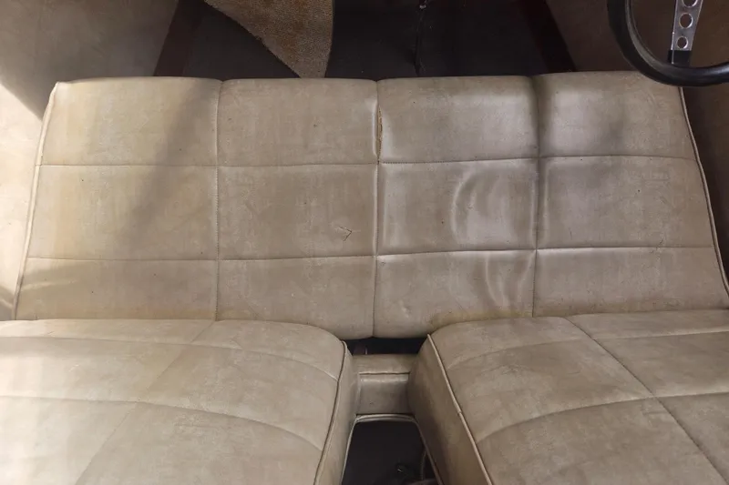 Slide: The Image of Vintage beige leather seats in a 1960 Chris Craft 19 Capri boat interior. - 13