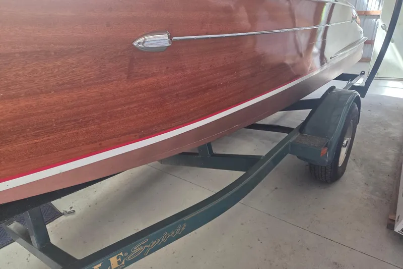 Slide: The Image of 1960 Custom Chris Craft 19 Capri boat on trailer, showcasing polished wood finish. - 18