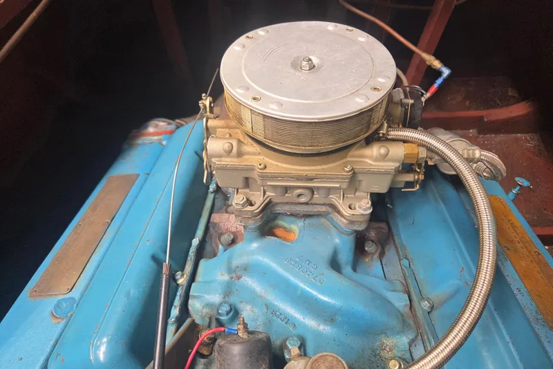 Slide: The Image of 1960 Chris Craft 19 Capri engine, showcasing vintage blue motor and carburetor details. - 19
