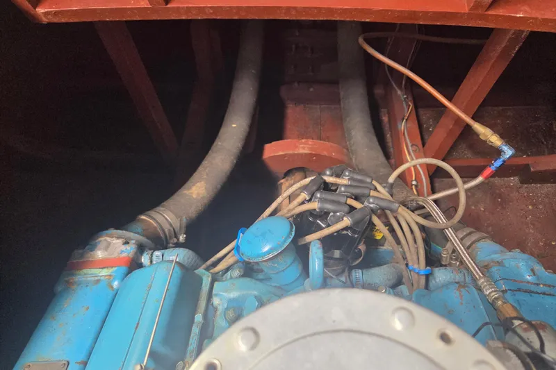 Slide: The Image of Engine compartment of a 1960 Chris Craft 19 Capri boat, showcasing vintage mechanical components. - 22