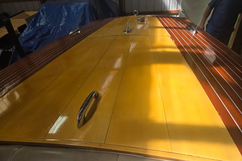 Slide: The Image of 1960 Chris Craft 19 Capri boat with polished wooden deck in sunlight. - 4