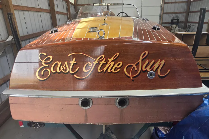 Slide: The Image of 1960 Custom Chris Craft 19 Capri boat named "East of the Sun" in storage. - 5