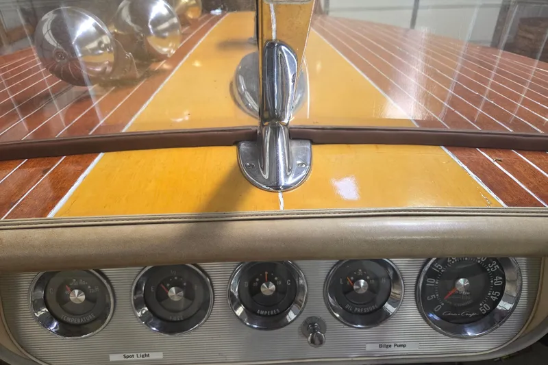 Slide: The Image of 1960 Chris Craft 19 Capri dashboard with vintage gauges and polished wood finish. - 8