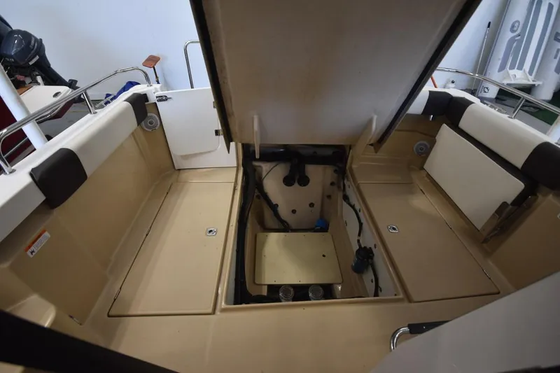 Slide: The Image of 2018 Ranger Tugs R-23 boat interior with open engine compartment. - 12