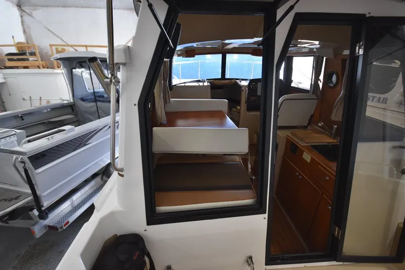 Slide: The Image of Interior view of 2018 Ranger Tugs R-23 boat with seating and kitchenette. - 14