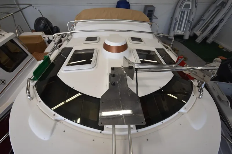 Slide: The Image of 2018 Ranger Tugs R-23 boat deck with windows and anchor setup in storage. - 18