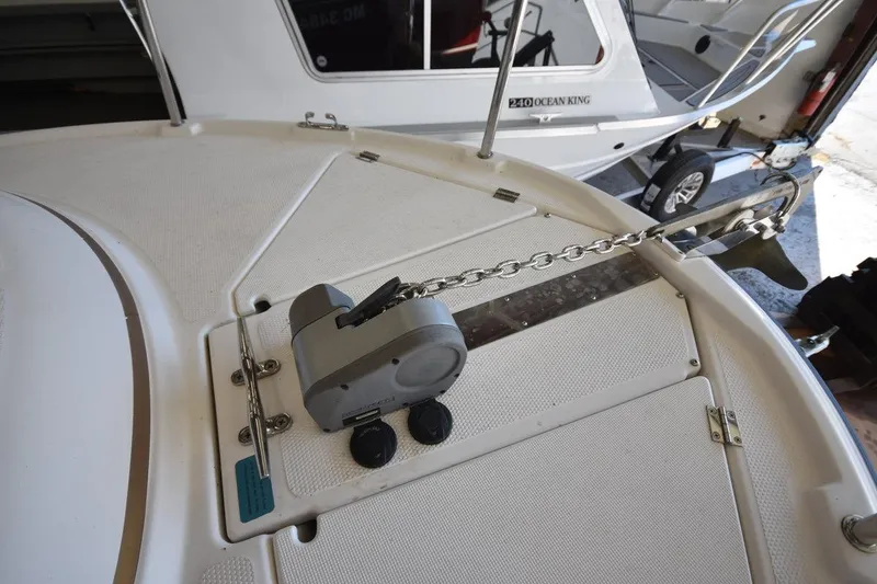 Slide: The Image of 2018 Ranger Tugs R-23 boat anchor system on deck, featuring a chain and winch. - 19