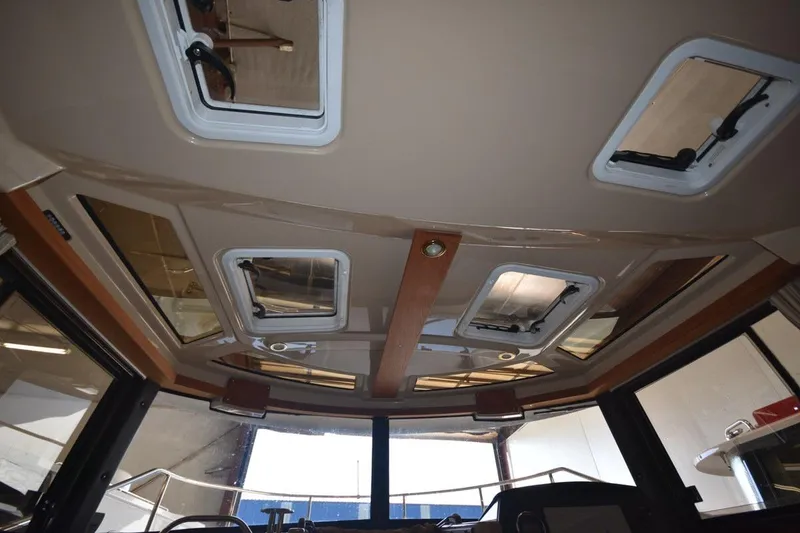 Slide: The Image of Interior ceiling view of 2018 Ranger Tugs R-23 boat with multiple hatches and windows. - 20