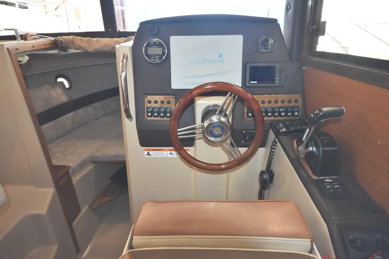 Slide: The Image of 2018 Ranger Tugs R-23 boat interior with steering wheel and navigation controls. - 21