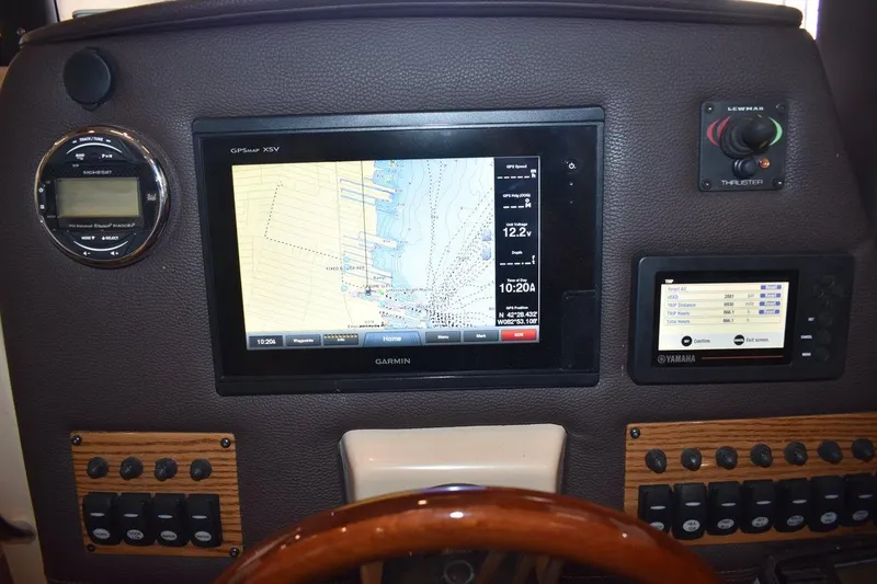 Slide: The Image of 2018 Ranger Tugs R-23 dashboard with Garmin GPS and Yamaha controls. - 23