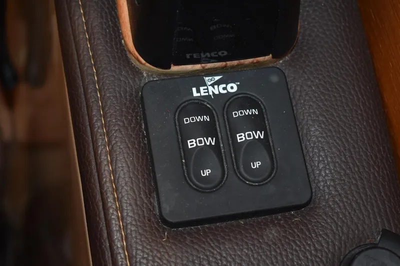 Slide: The Image of Lenco trim tab controls on 2018 Ranger Tugs R-23 boat dashboard. - 25