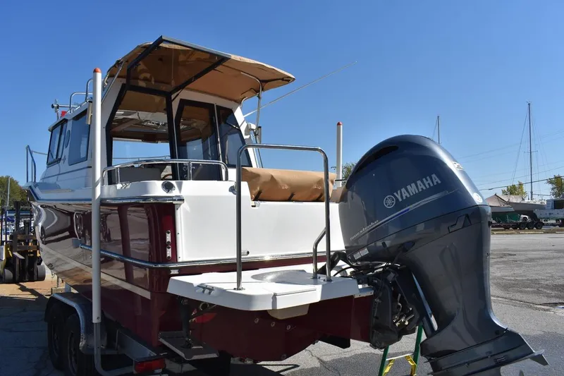 Slide: The Image of 2018 Ranger Tugs R-23 boat with Yamaha outboard motor, docked under clear blue sky. - 5