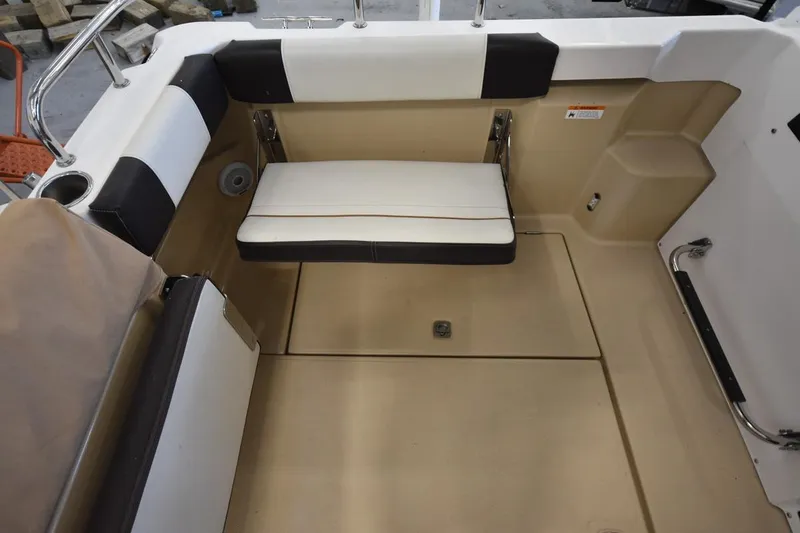 Slide: The Image of 2018 Ranger Tugs R-23 boat interior with cushioned seating and storage area. - 9