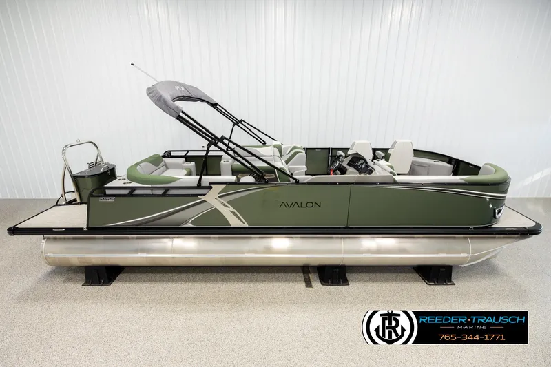The Image of 2026 Avalon LSZ EL pontoon boat in showroom, featuring sleek green design and modern seating. - 1