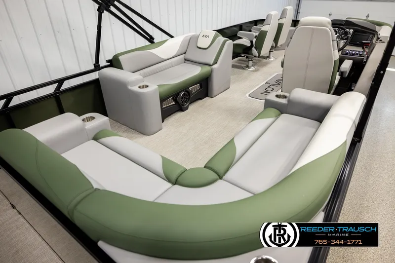 Slide: The Image of 2026 Avalon LSZ EL pontoon boat interior with green and gray seating, cup holders, and steering console. - 12