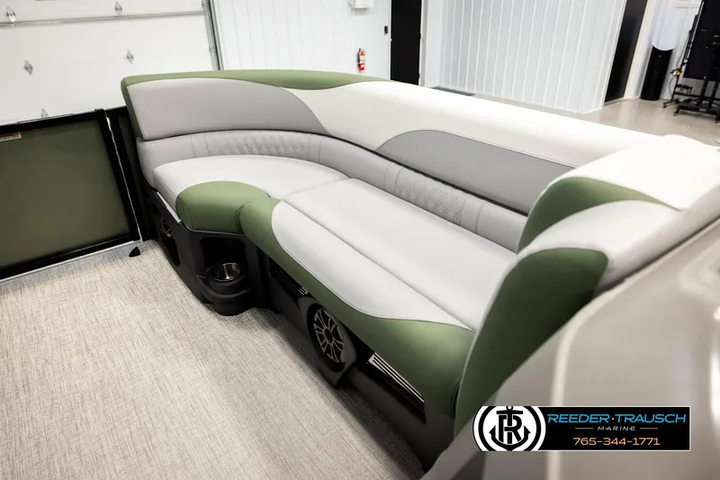 Slide: The Image of Luxurious seating in 2026 Avalon LSZ EL pontoon boat, featuring green and gray upholstery. - 19