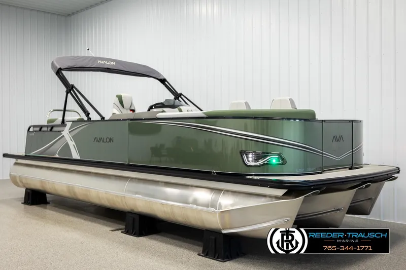 Slide: The Image of 2026 Avalon LSZ EL pontoon boat in showroom, featuring sleek design and modern amenities. - 2