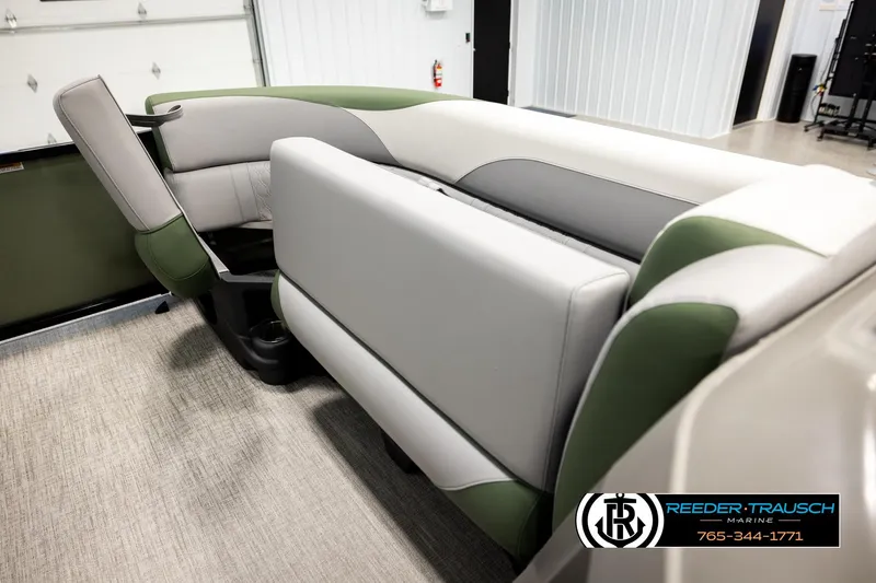 Slide: The Image of 2026 Avalon LSZ EL boat interior with green and gray seating, Reeder-Trausch Marine logo. - 20