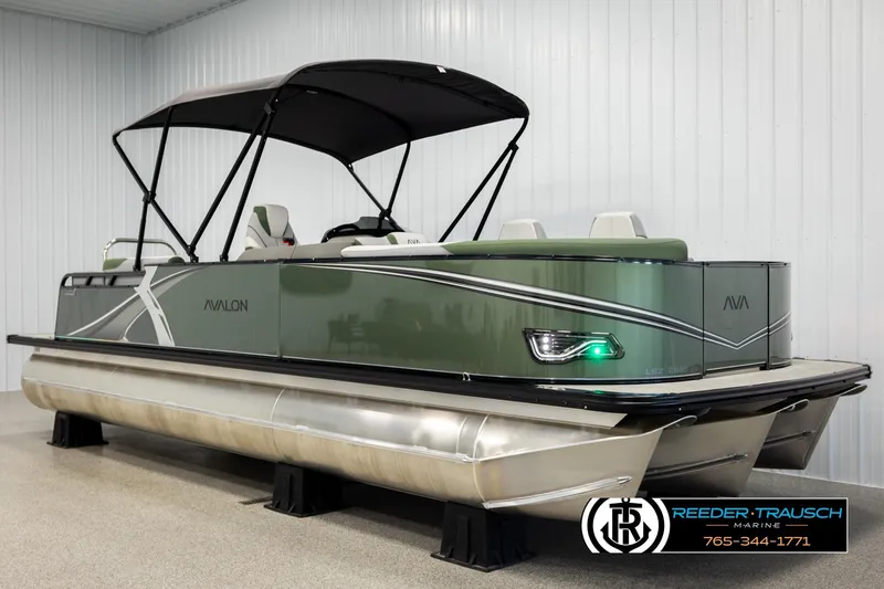 Slide: The Image of 2026 Avalon LSZ EL pontoon boat with canopy in showroom setting. - 3