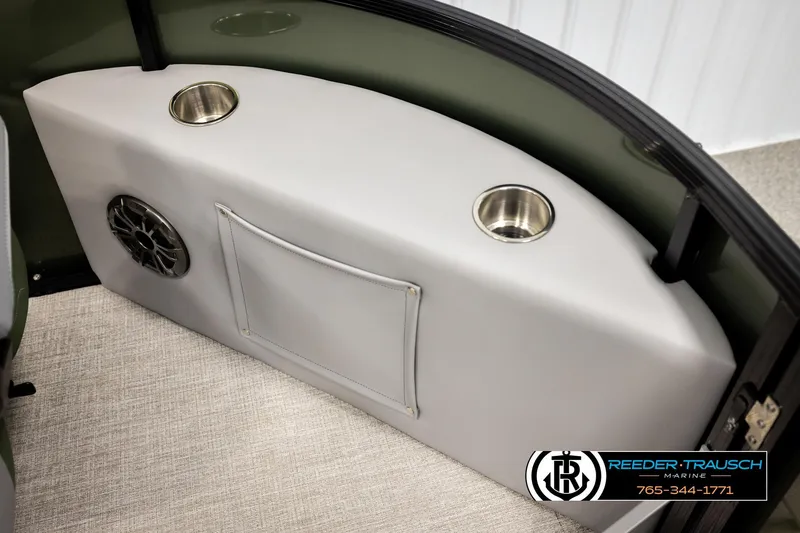 Slide: The Image of 2026 Avalon LSZ EL boat interior with cup holders and speaker, Reeder-Trausch Marine logo. - 40