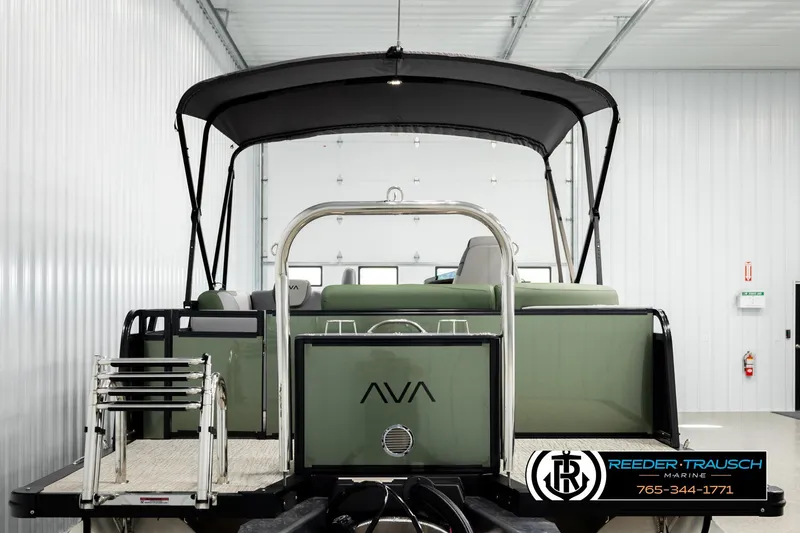 Slide: The Image of 2026 Avalon LSZ EL pontoon boat in showroom, featuring sleek design and canopy. - 7