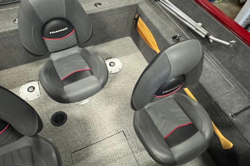 Slide: The Image of 2023 Tracker Pro Guide V-175 WT boat interior with gray seats and carpeted flooring. - 11