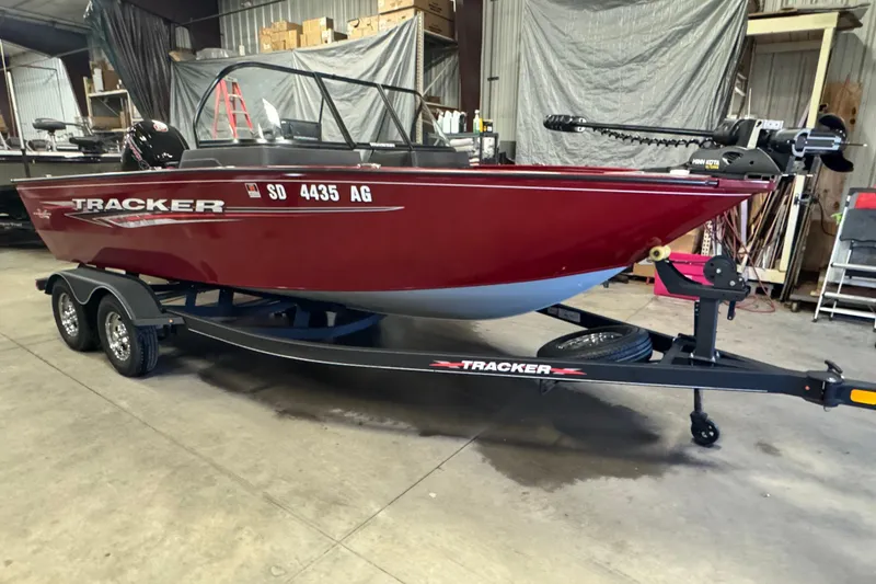 Slide: The Image of 2023 Tracker Pro Guide V-175 WT boat on trailer in a garage setting. - 2