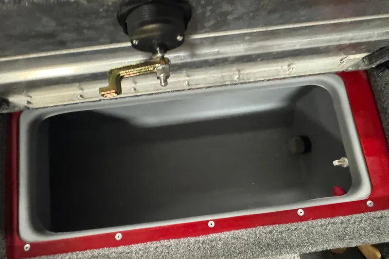 Slide: The Image of 2023 Tracker Pro Guide V-175 WT livewell interior with open lid and latch mechanism. - 20