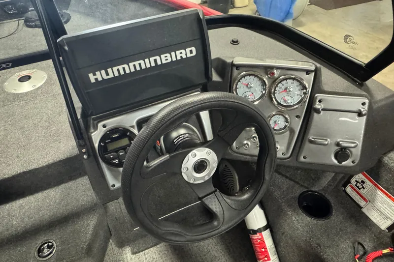 Slide: The Image of 2023 Tracker Pro Guide V-175 WT dashboard with Humminbird display and steering wheel. - 7