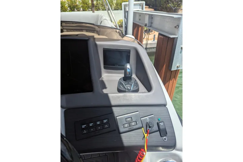 Slide: The Image of 2023 Bennington R 27 RSRAX2 boat dashboard with controls and display screen. - 13