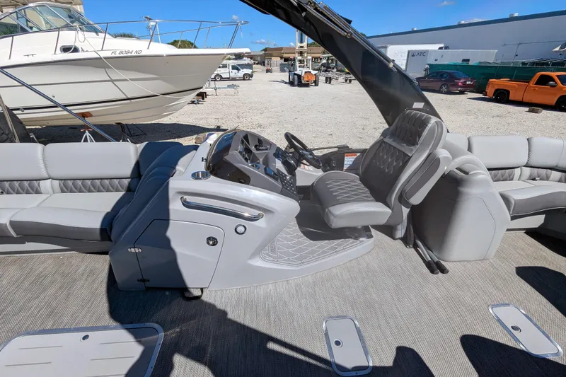 Slide: The Image of 2023 Bennington R 27 RSRAX2 pontoon boat interior with luxurious seating and modern helm. - 15