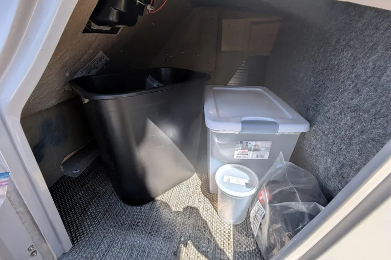 Slide: The Image of Storage compartment in 2023 Bennington R 27 RSRAX2 with bins and containers. - 16