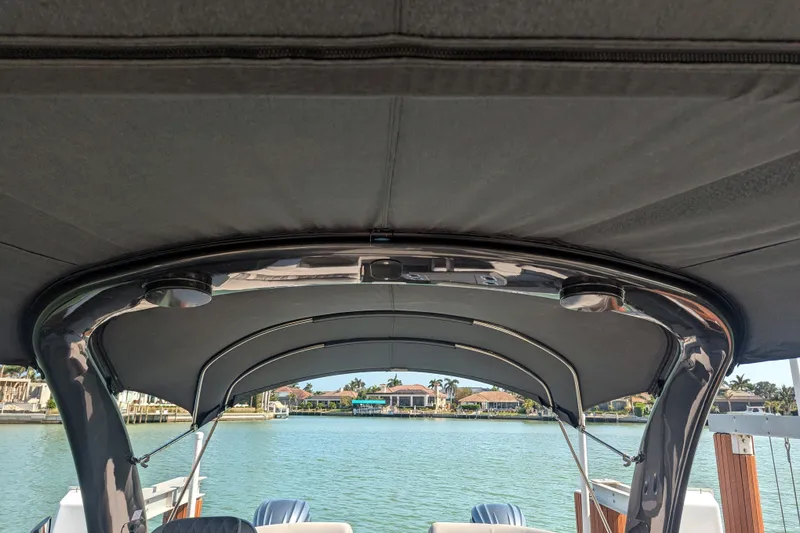 Slide: The Image of 2023 Bennington R 27 RSRAX2 boat canopy with waterfront view. - 18
