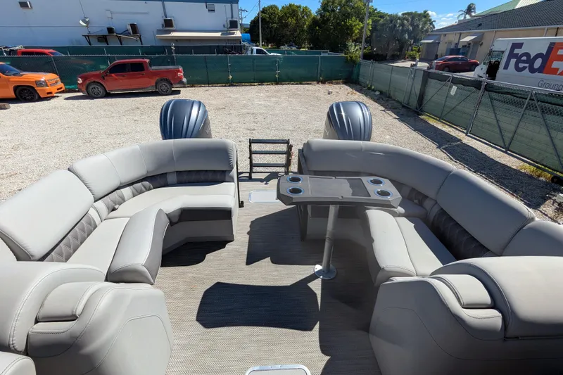 Slide: The Image of 2023 Bennington R 27 RSRAX2 pontoon boat with luxurious seating and table setup. - 23