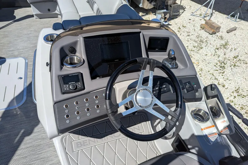 Slide: The Image of 2023 Bennington R 27 RSRAX2 boat dashboard with steering wheel and controls. - 8