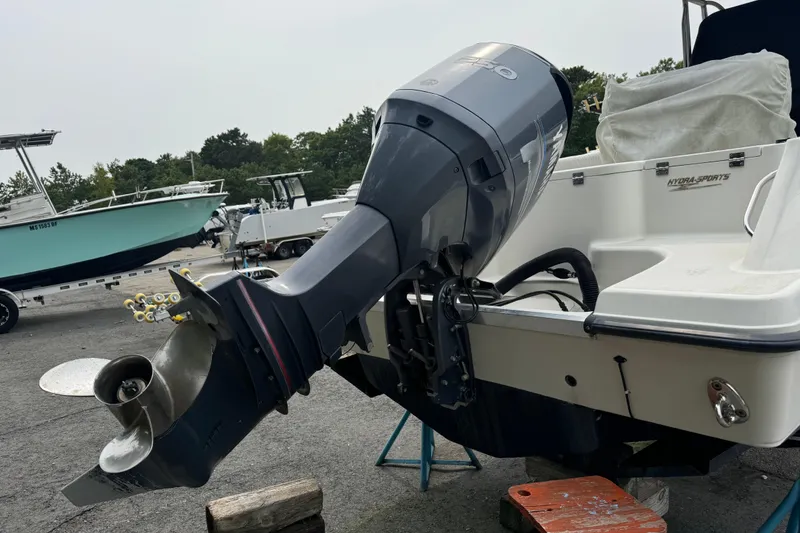 Slide: The Image of 2004 Hydra-Sports Vector 2400 CC boat with outboard motor in a marina setting. - 2