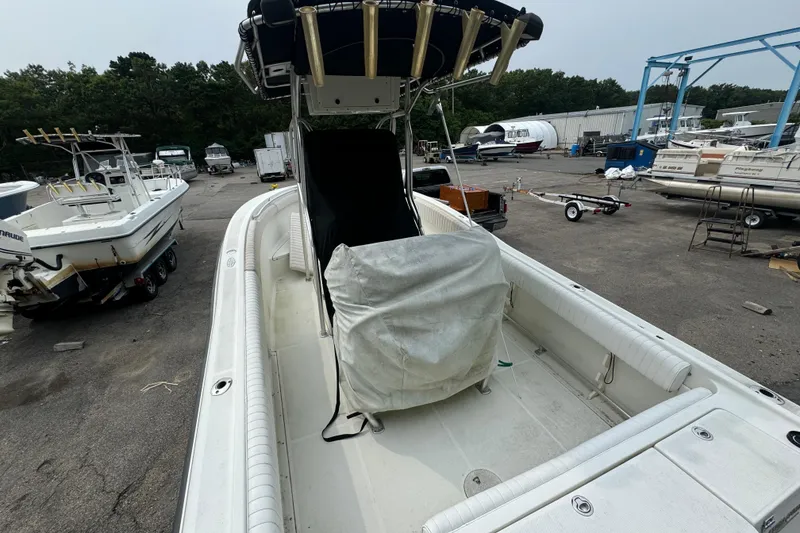 Slide: The Image of 2004 Hydra-Sports Vector 2400 CC boat in a marina with other vessels. - 3