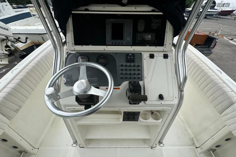 Slide: The Image of 2004 Hydra-Sports Vector 2400 CC boat console with steering wheel and navigation controls. - 4