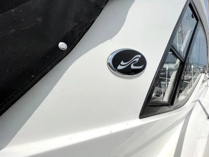 Slide: The Image of 2019 Sea Ray Sundancer 350 Coupe boat exterior with logo and window detail. - 10