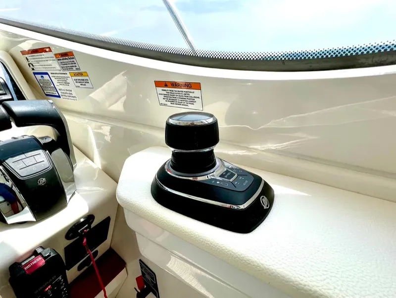 Slide: The Image of 2019 Sea Ray Sundancer 350 Coupe helm with joystick control and warning labels. - 15
