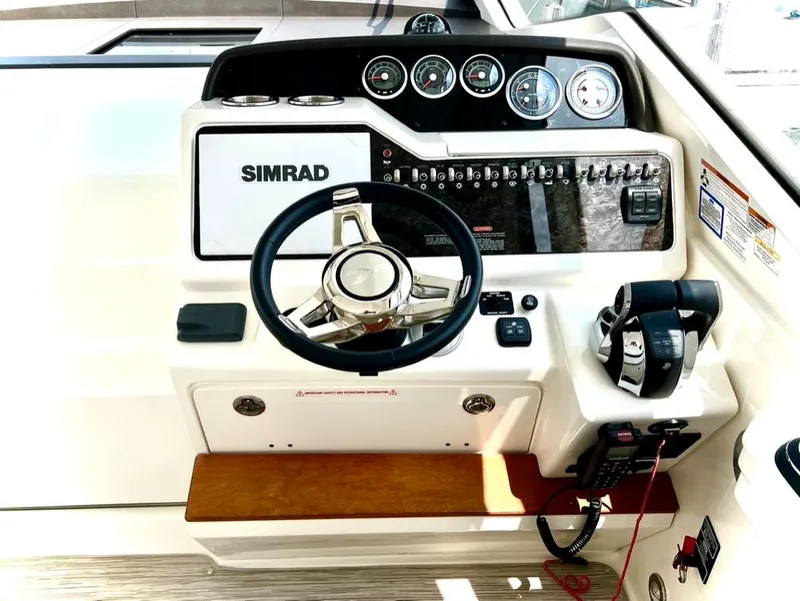 Slide: The Image of Control panel of 2019 Sea Ray Sundancer 350 Coupe with steering wheel and Simrad display. - 17