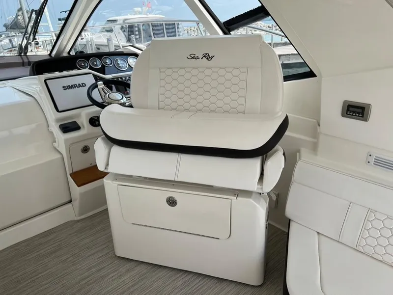 Slide: The Image of 2019 Sea Ray Sundancer 350 Coupe helm with luxurious white seating and modern controls. - 20