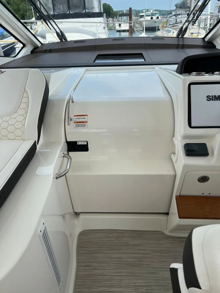 Slide: The Image of 2019 Sea Ray Sundancer 350 Coupe interior with modern dashboard and seating. - 23