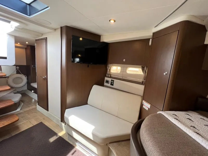 Slide: The Image of Interior of 2019 Sea Ray Sundancer 350 Coupe with modern seating and TV. - 32
