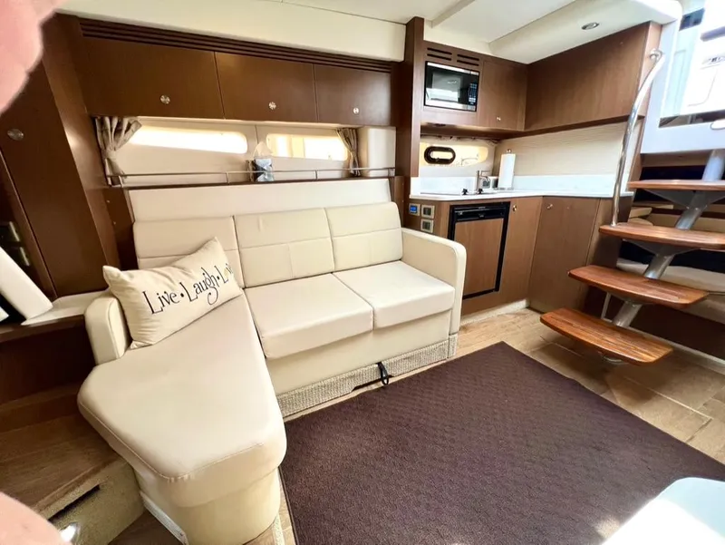 Slide: The Image of Interior of 2019 Sea Ray Sundancer 350 Coupe with modern kitchen and cozy seating area. - 34