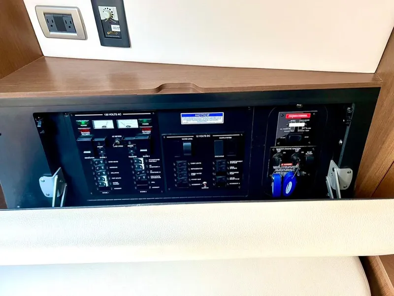 Slide: The Image of Electrical panel inside 2019 Sea Ray Sundancer 350 Coupe yacht, featuring various switches and controls. - 36