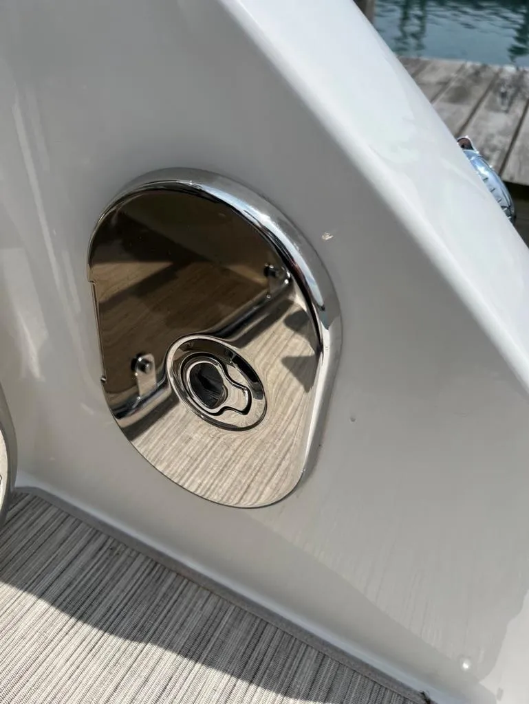 Slide: The Image of Close-up of a 2019 Sea Ray Sundancer 350 Coupe's chrome fuel cap. - 37